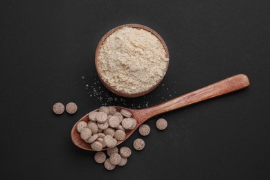 Different types of brewer`s yeast on black background, flat lay