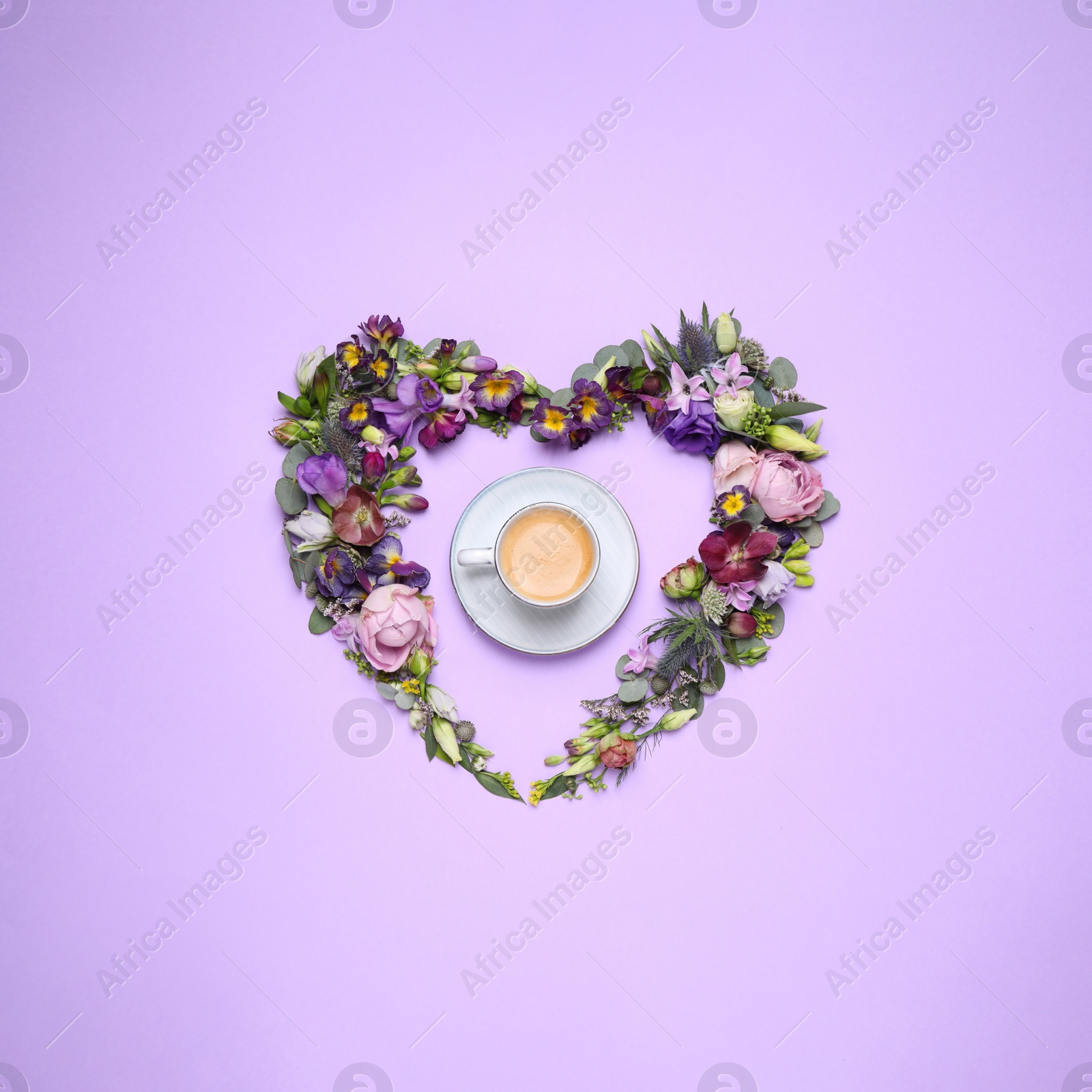 Photo of Beautiful heart made of different flowers and coffee on violet background, flat lay