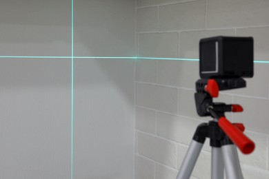Cross lines of laser level on white walls
