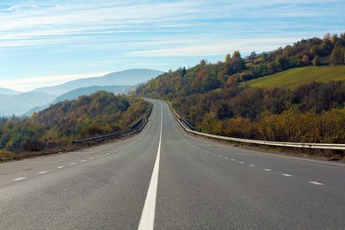 Landscape with asphalt road leading to mountains