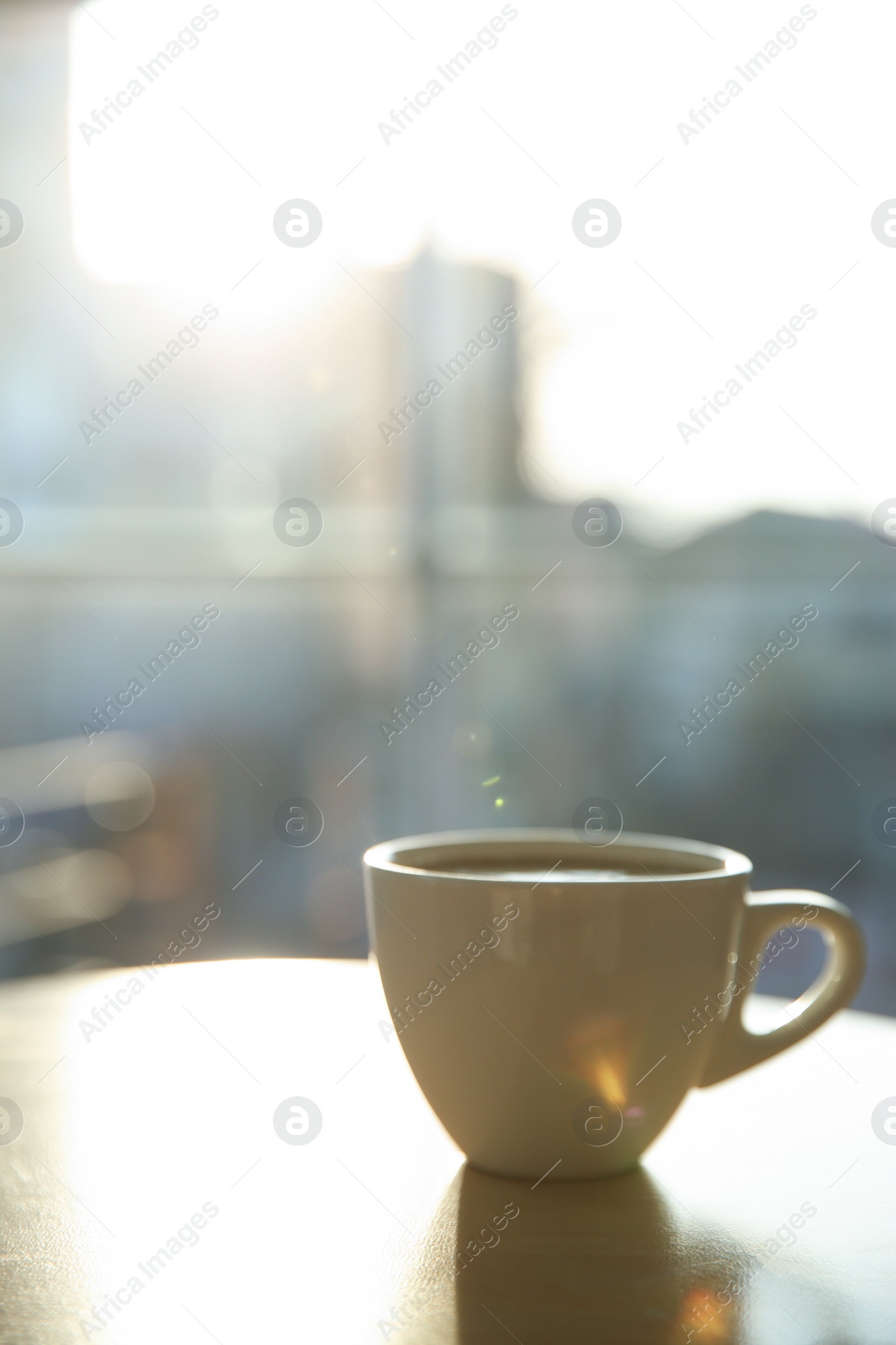 Photo of Cup of hot drink on table in morning. Space for text