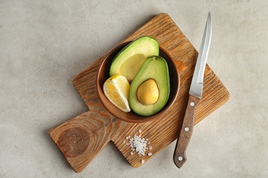 Flat lay composition with ripe avocado and lemon on grey background