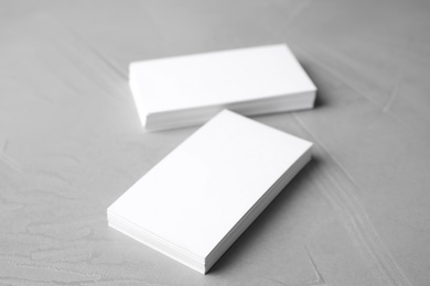Photo of Blank business cards on light grey stone background, closeup. Mock up for design