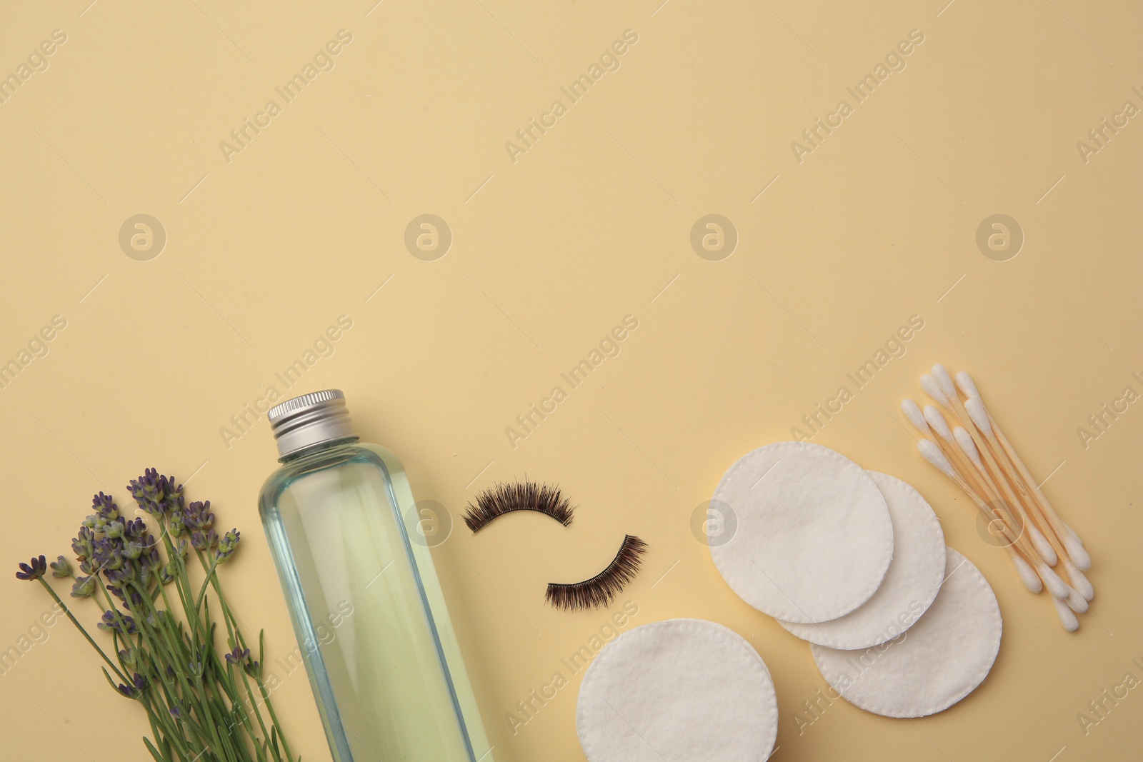 Photo of Flat lay composition with makeup remover and lavender on yellow background. Space for text