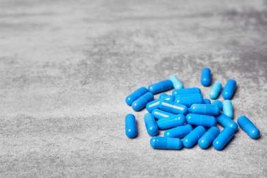 Photo of Blue capsules on grey background