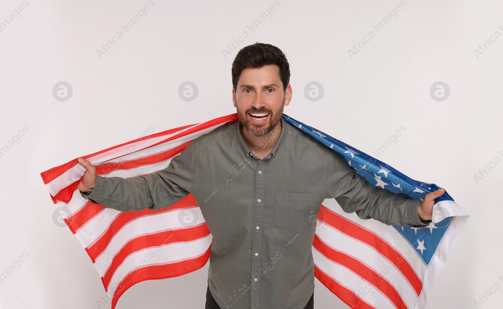 Photo of 4th of July - Independence Day of USA. Happy man with American flag on white background