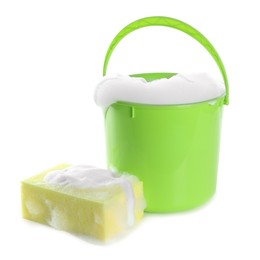 Photo of Plastic bucket with foam and sponge on white background. Cleaning supplies