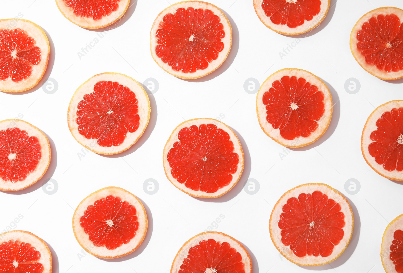 Photo of Fresh sliced ripe grapefruits on white background, top view