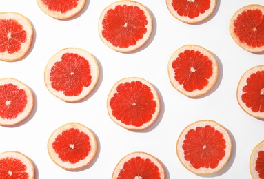 Fresh sliced ripe grapefruits on white background, top view