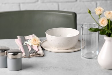 Beautiful table setting with fabric napkin and roses indoors