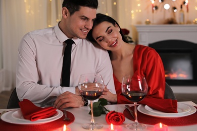 Happy couple having romantic dinner on Valentine's day in restaurant