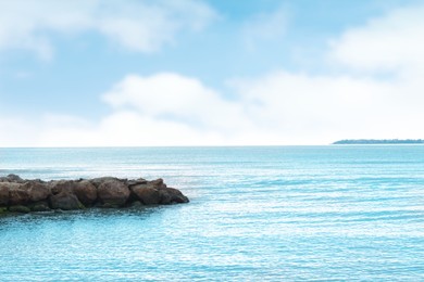 Photo of Beautiful view on sea with rock breakwater