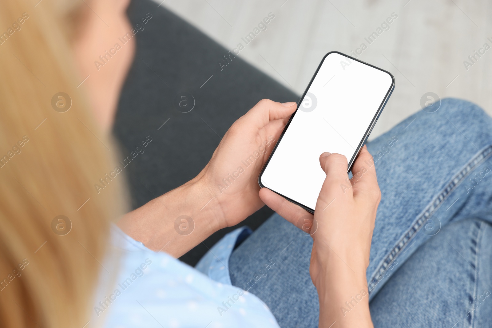 Photo of Woman using smartphone at home, closeup. Space for text