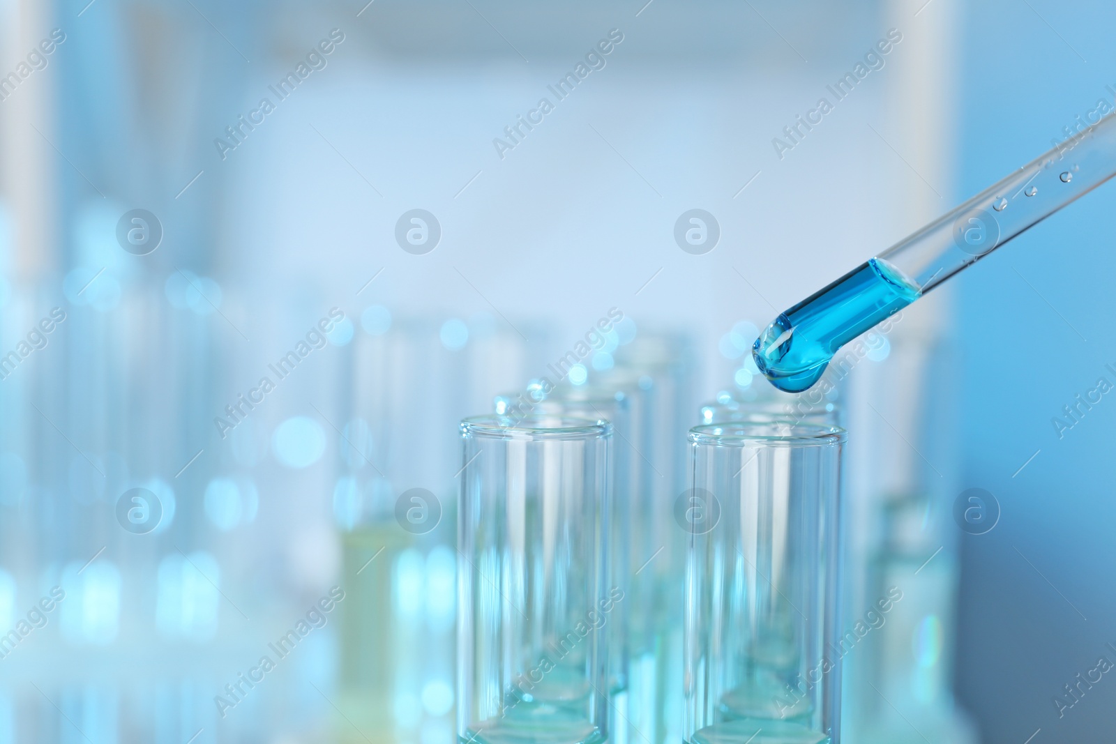 Photo of Dripping reagent into test tube with sample at laboratory, closeup. Chemical analysis