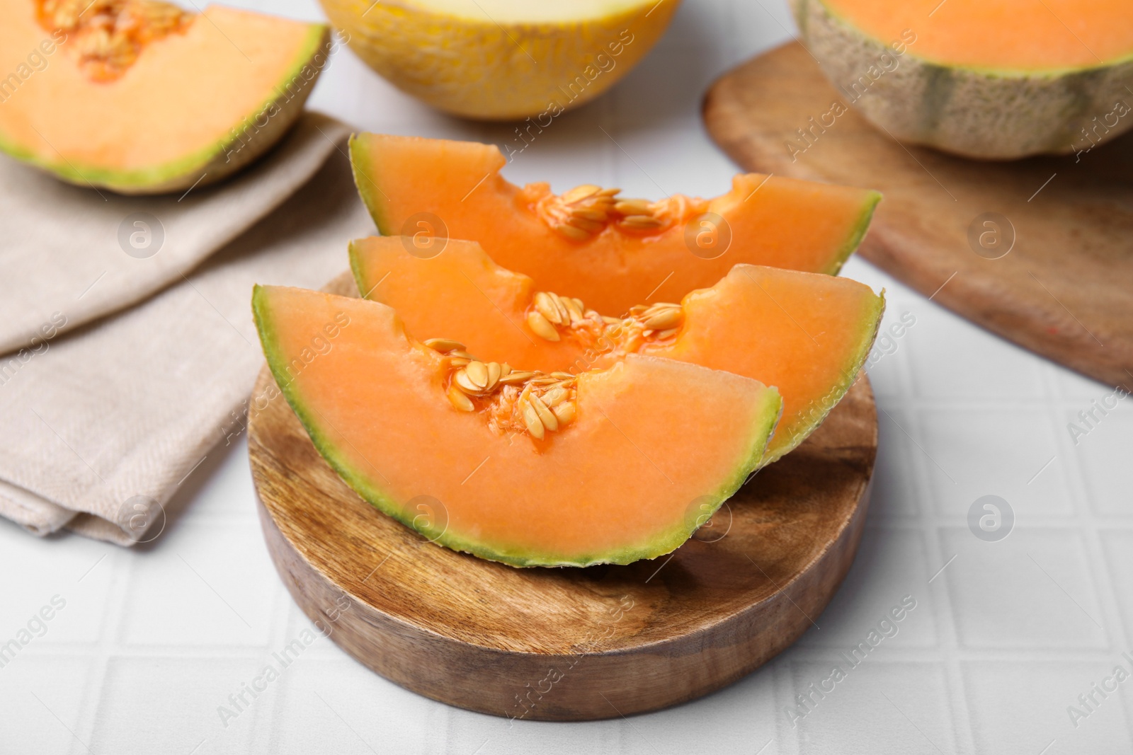 Photo of Tasty colorful ripe melons on white table