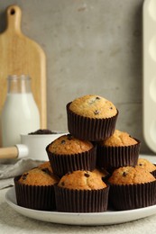 Delicious sweet muffins with chocolate chips on light table