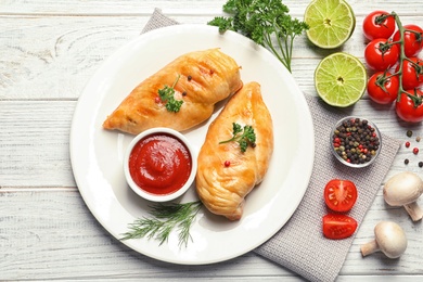 Tasty cooked chicken breasts served on wooden table, flat lay