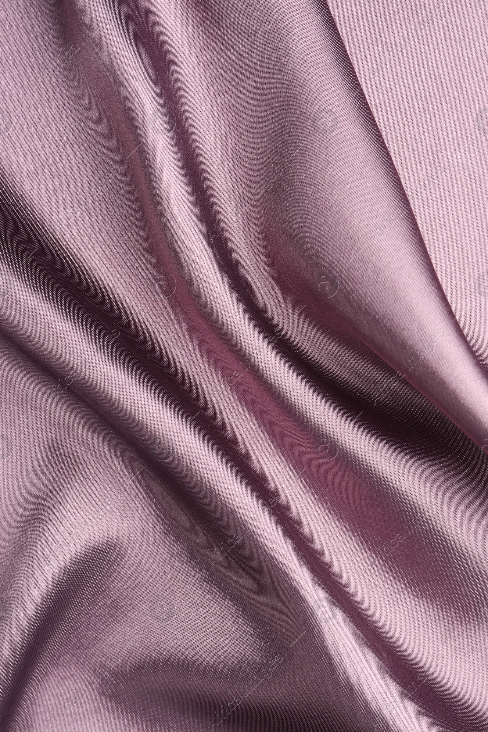 Photo of Crumpled dark purple silk fabric as background, top view