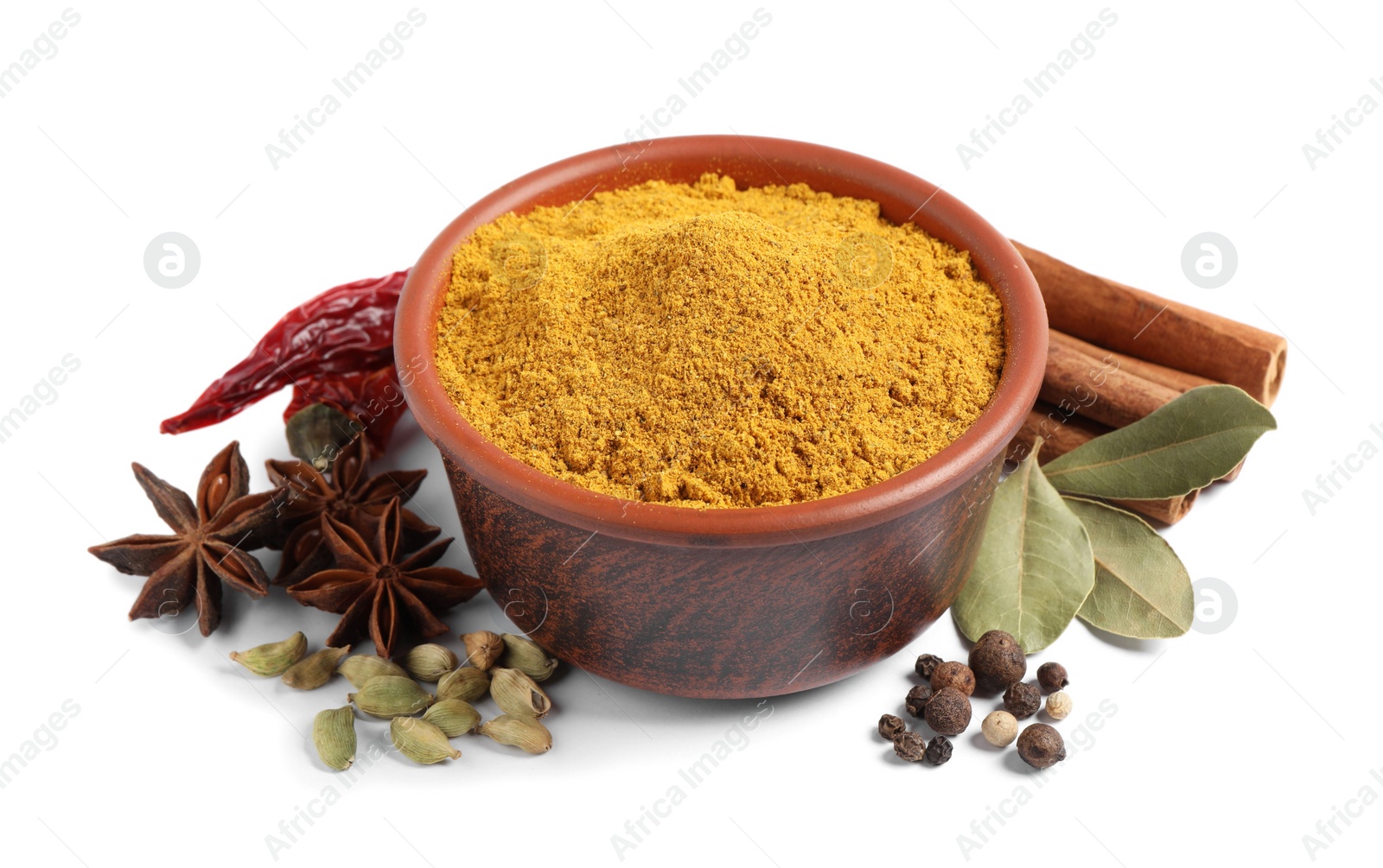 Photo of Curry powder in bowl and other spices isolated on white