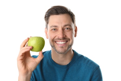 Photo of Man with perfect teeth and green apple on white background