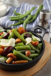 Photo of Delicious salad with green beans, mushrooms and cheese on table, closeup