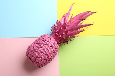 Pink pineapple on color background, top view. Creative concept