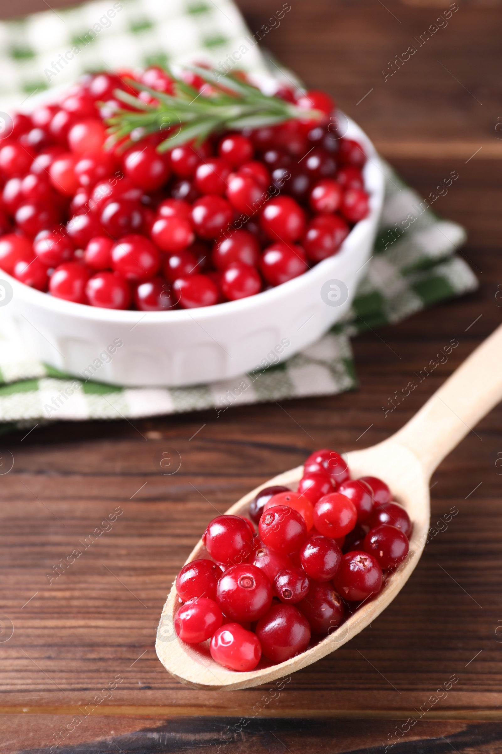 Photo of Fresh ripe cranberries on wooden table, closeup