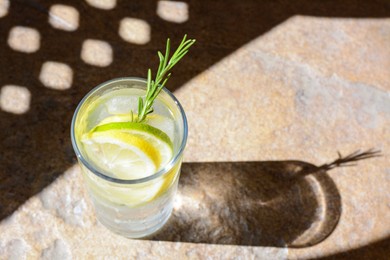 Photo of Summer refreshing lemonade on light brown table, space for text