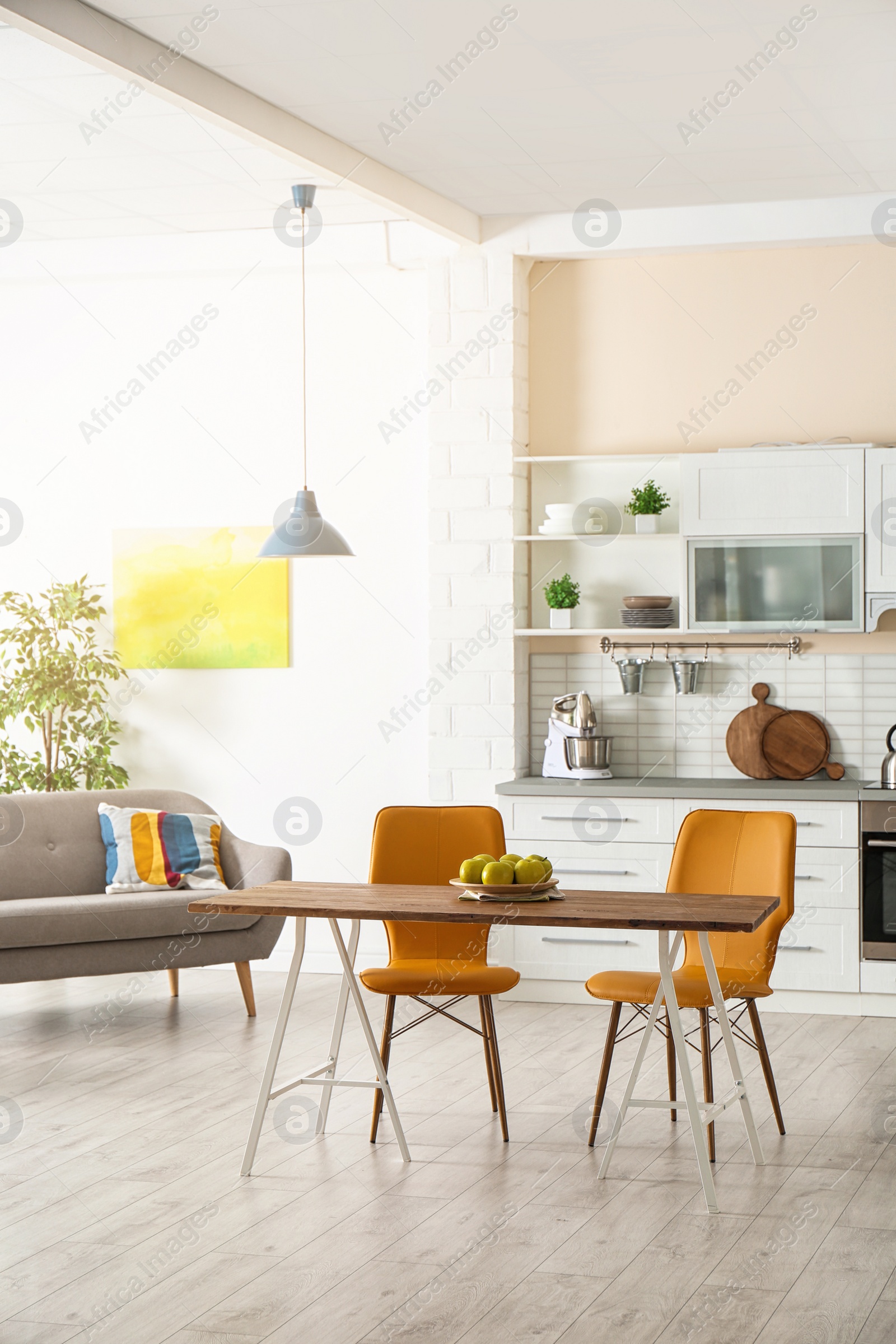 Photo of Stylish apartment interior with kitchen furniture and sofa