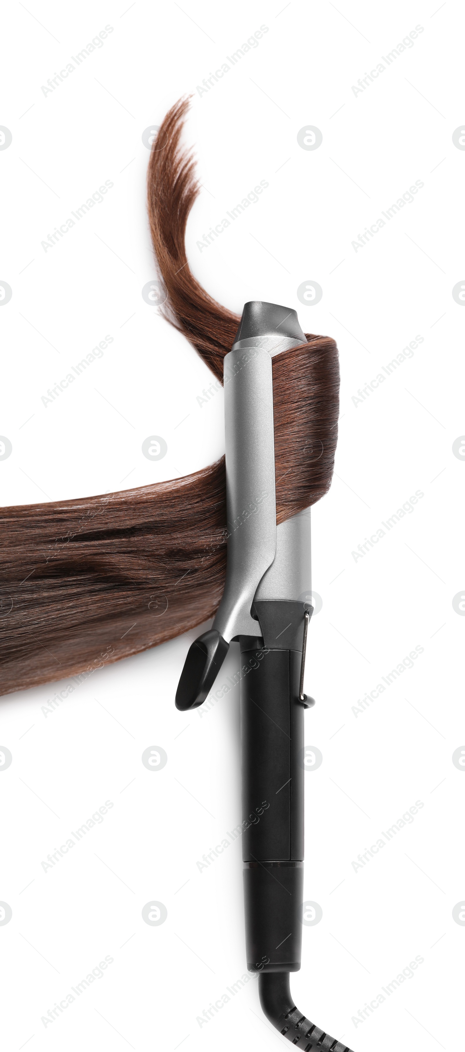 Photo of Curling iron with brown hair lock on white background, top view