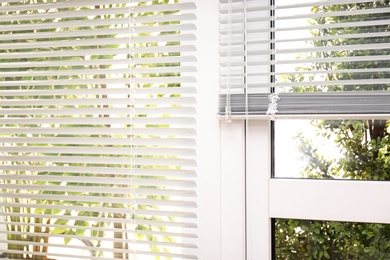 Open white horizontal window blinds, closeup view