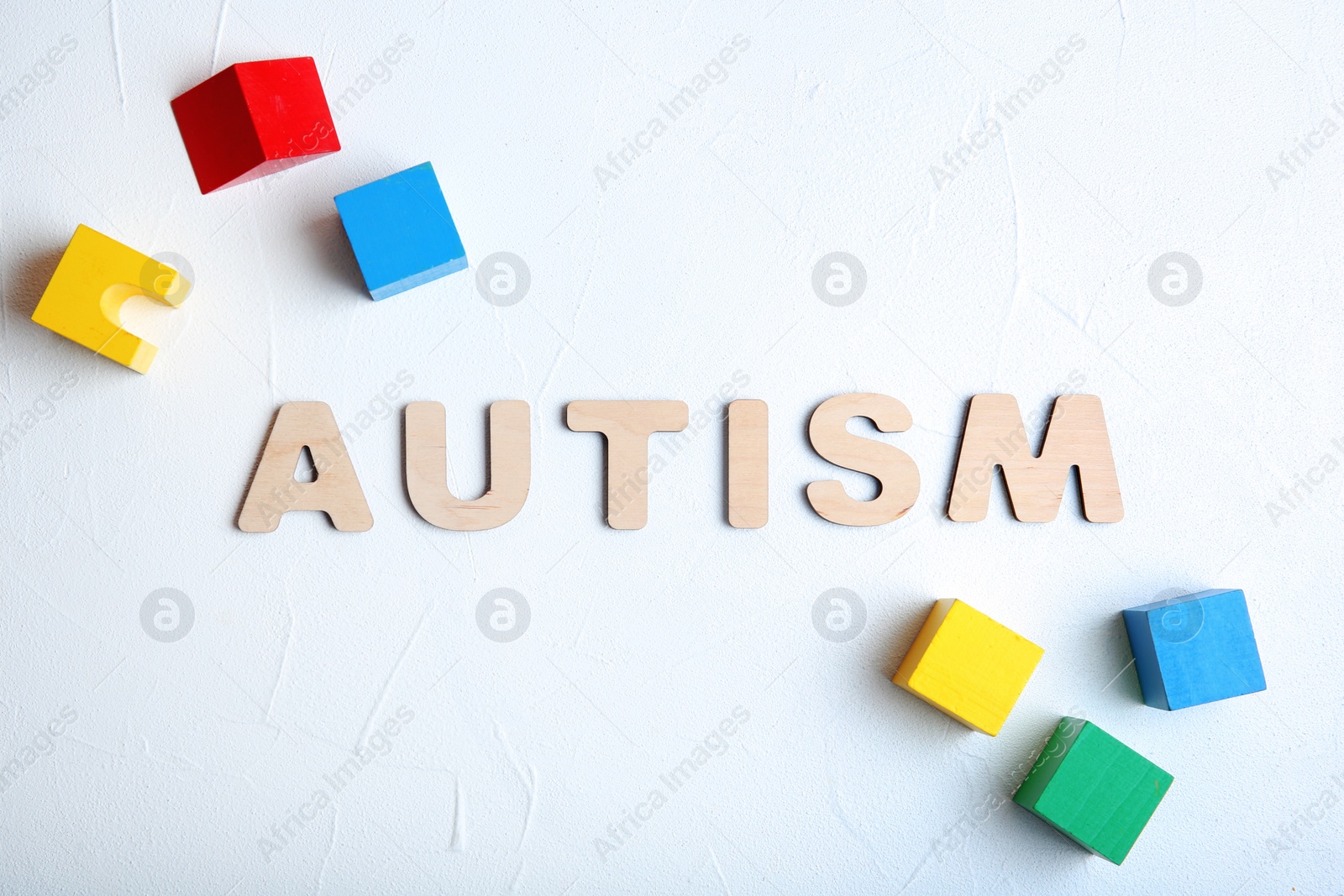 Photo of Flat lay composition with word AUTISM on light background