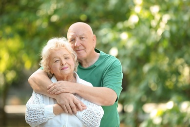 Portrait of cute elderly couple in park