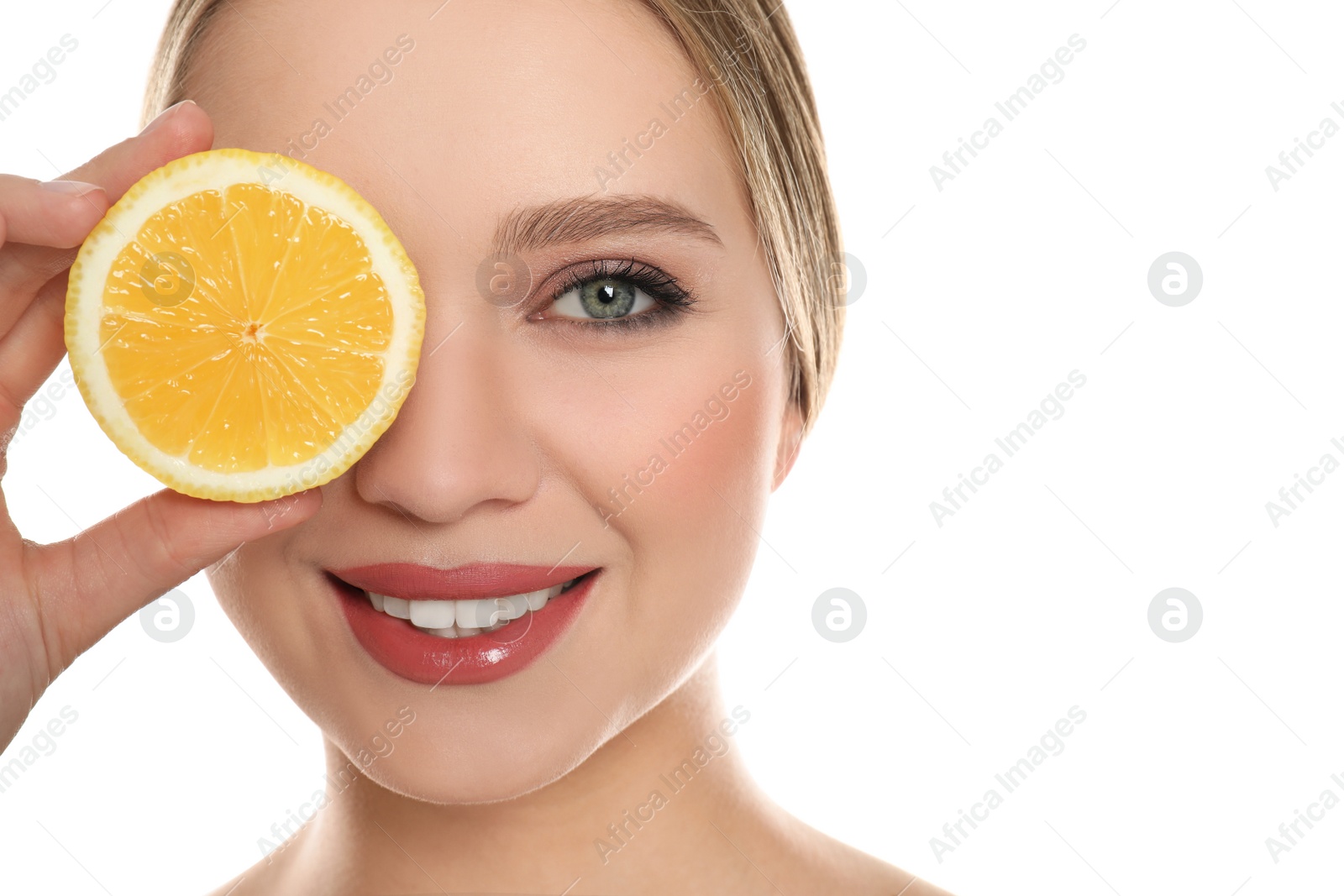 Photo of Young woman with cut lemon on white background. Vitamin rich food