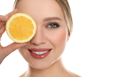 Photo of Young woman with cut lemon on white background. Vitamin rich food