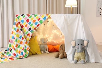 Play tent decorated with festive lights in modern child's room