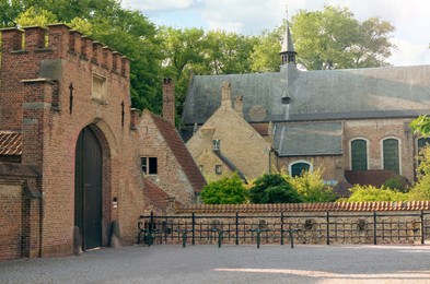 Photo of BRUGES, BELGIUM - JUNE 14, 2019: Beautiful view of entrance gate and the Princely Beguinage Ten Wijngaerde buildings