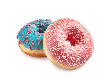 Delicious glazed doughnuts with sprinkles on white background