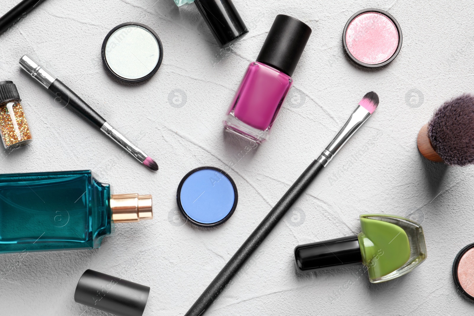 Photo of Flat lay composition with decorative cosmetics on gray background