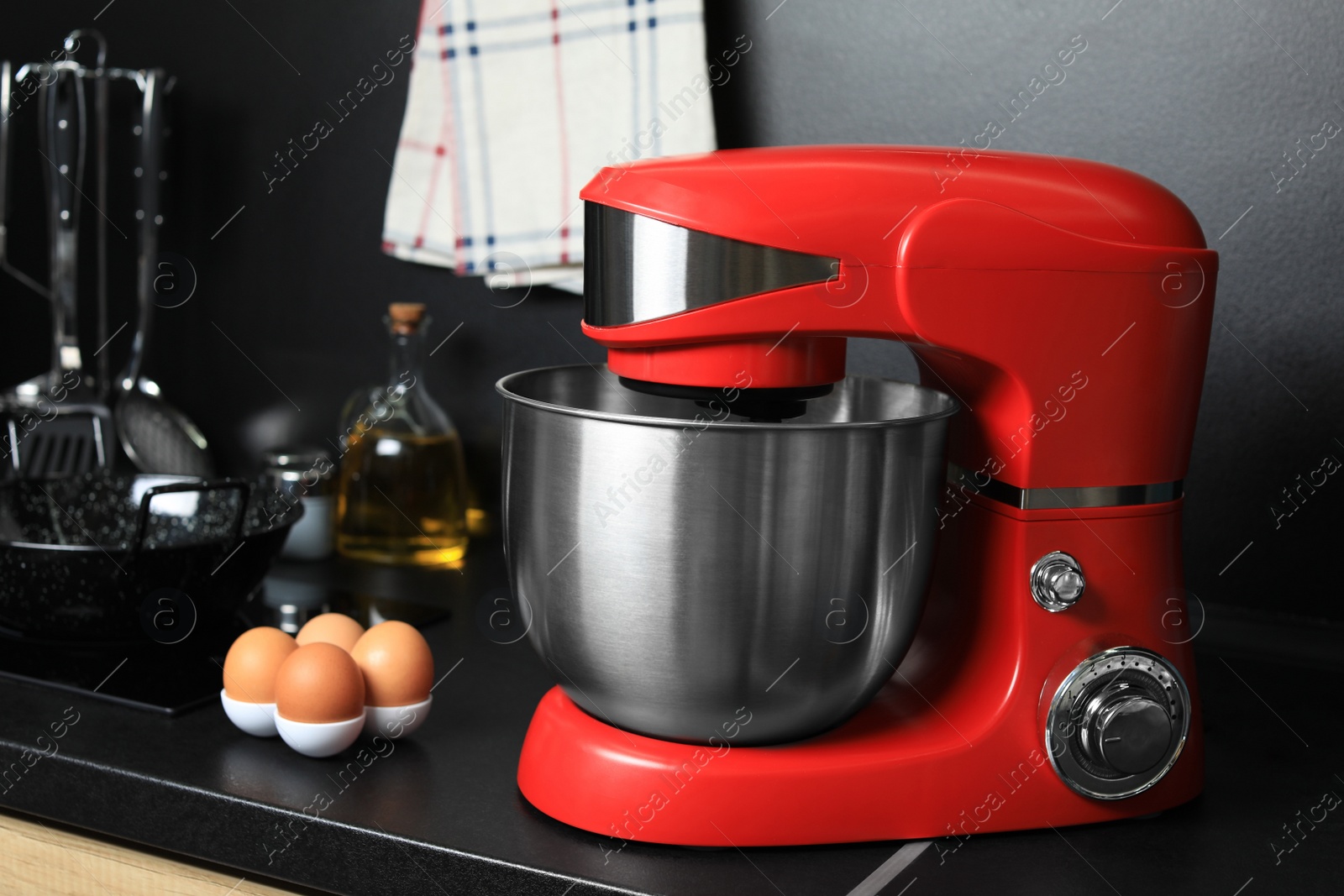 Photo of Modern stand mixer and ingredients on countertop in kitchen. Home appliance