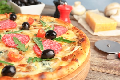 Photo of Delicious pizza with tomatoes and sausage on table, closeup