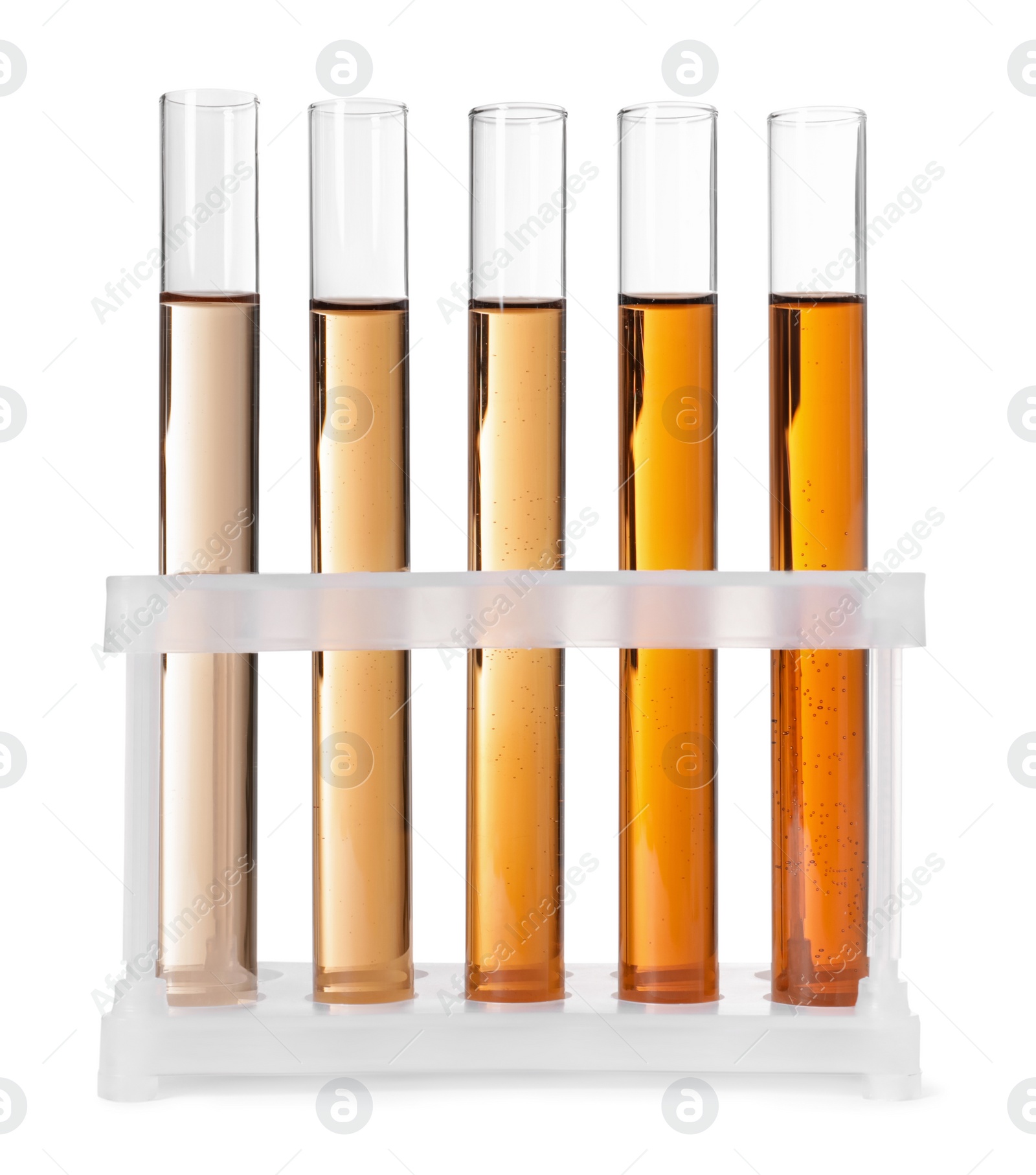 Photo of Test tubes with brown liquid in stand on white background