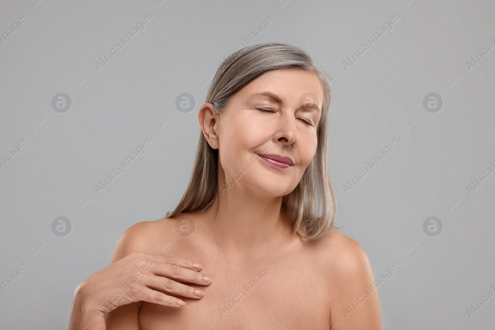 Photo of Beautiful woman with healthy skin on grey background