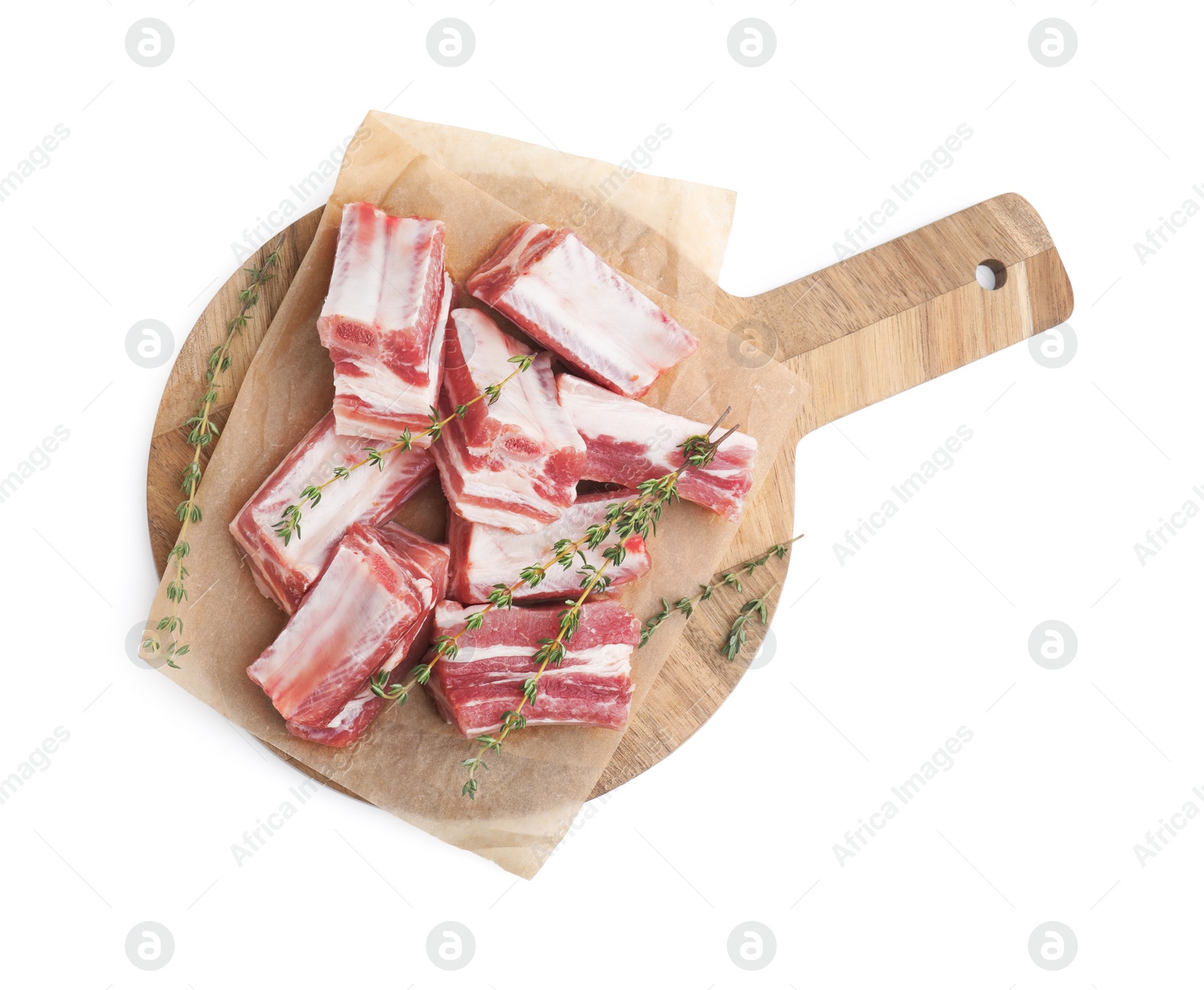 Photo of Cut raw pork ribs with thyme isolated on white, top view