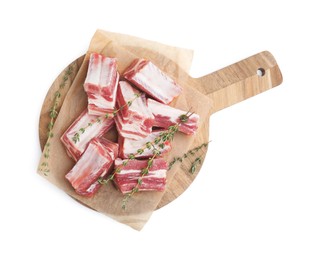 Cut raw pork ribs with thyme isolated on white, top view