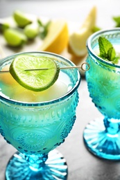 Photo of Melon ball cocktail served on table, closeup