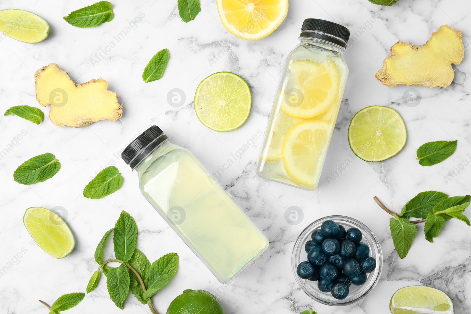 Photo of Flat lay composition with delicious natural lemonade on marble background