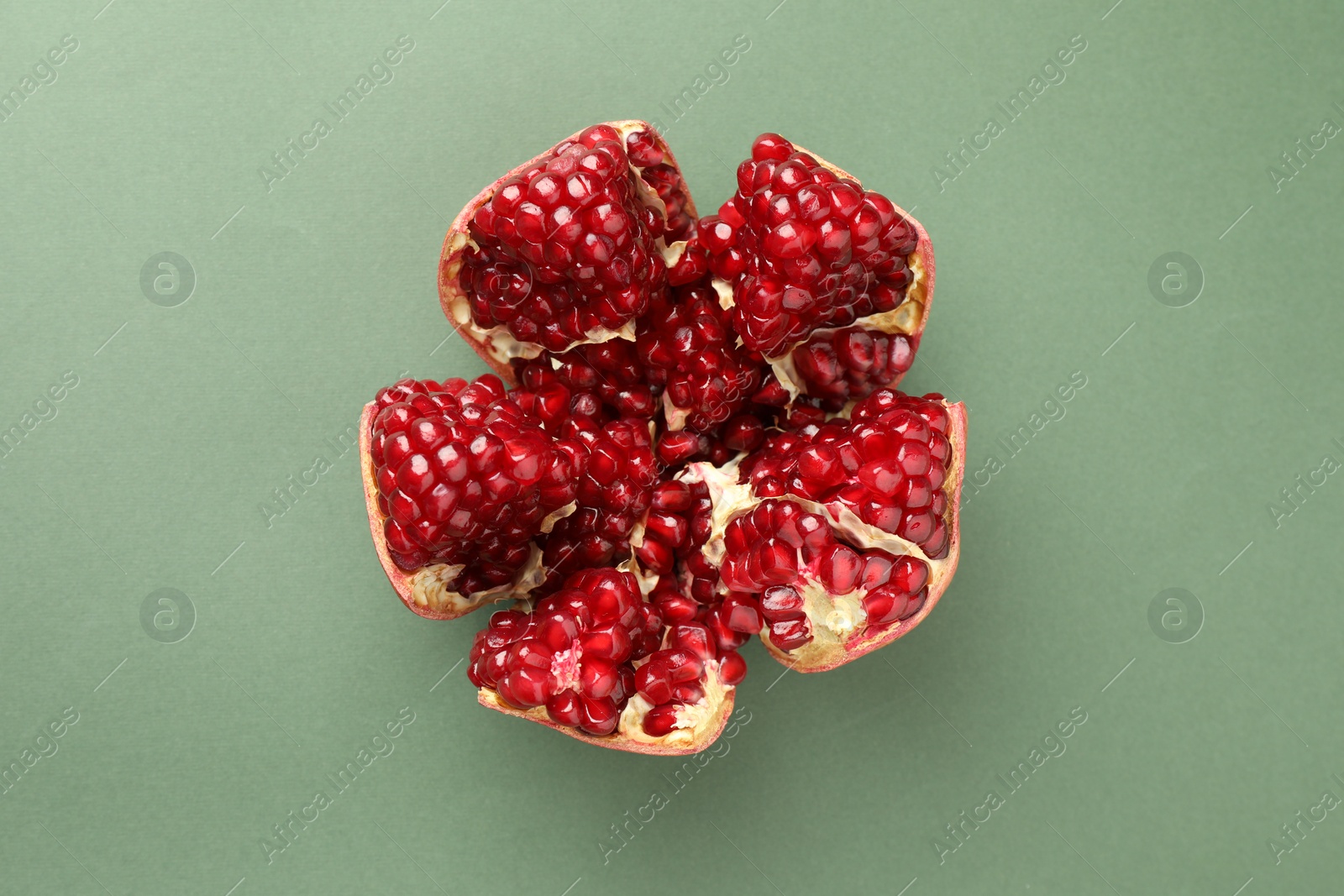 Photo of Fresh ripe pomegranate on pale green background, top view