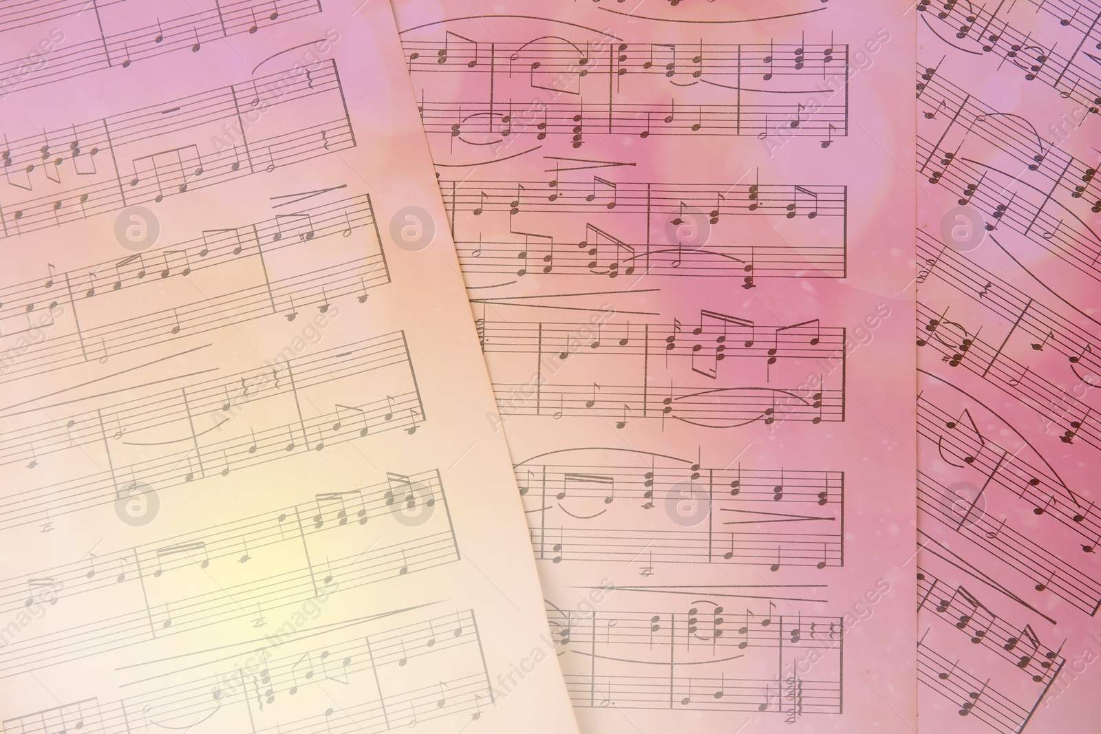 Image of Sheets with music notes as background, top view. Bokeh and color tone effects