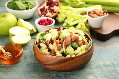 Photo of Delicious fresh celery salad on light blue wooden table